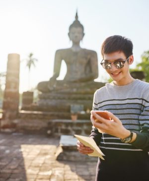 eSIM Thailand with a man holding his device