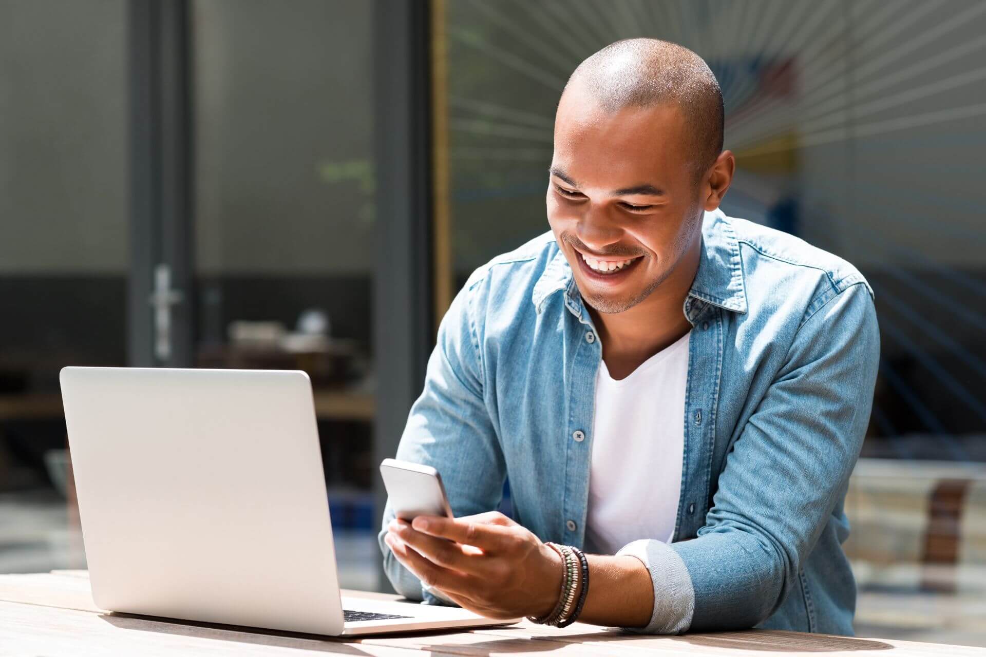 man using laptop and a smartphone