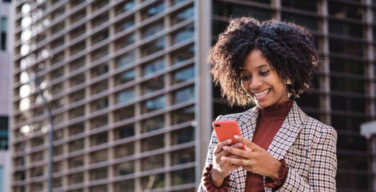 woman with smartphone in urban area