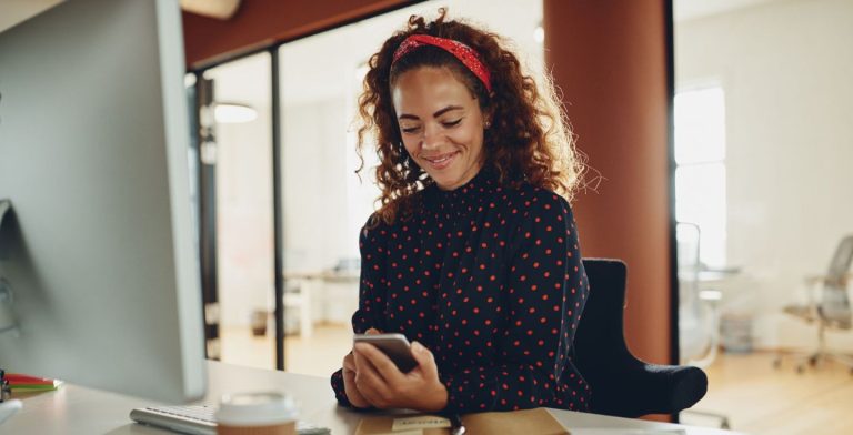 Woman texting in her office