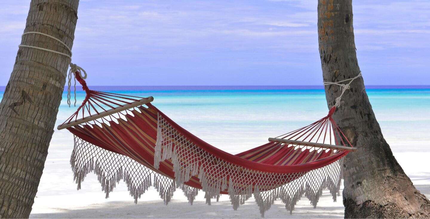 A hammock on the beach in the Bahamas.