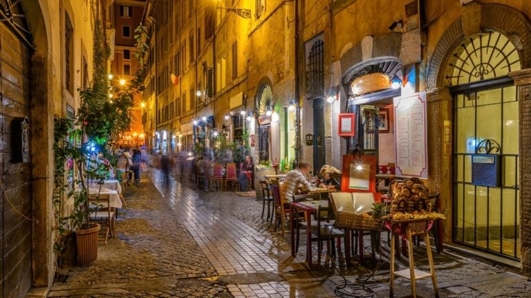 People enjoying a lovely evening in a Roman street at night