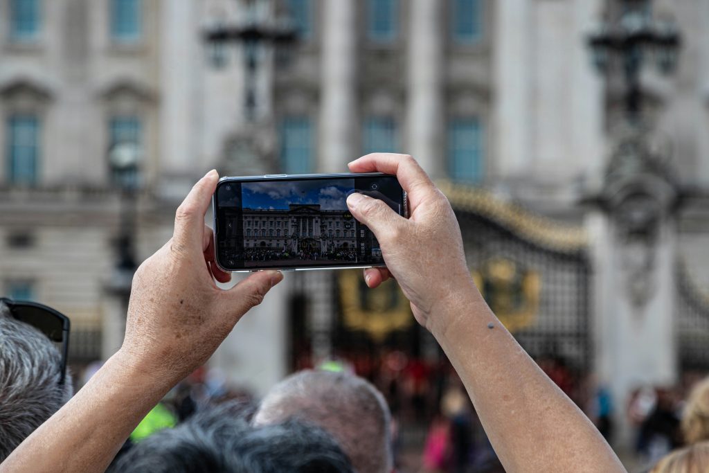 A London tourist using their cell phone.