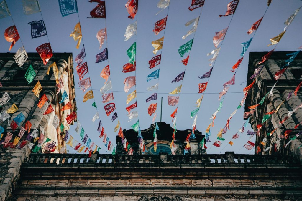 flags hanging from buildings in mexico 