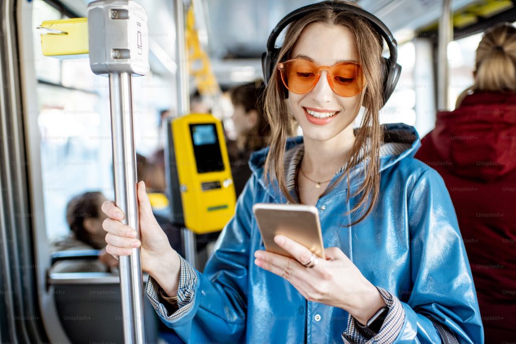 A woman streaming music while traveling