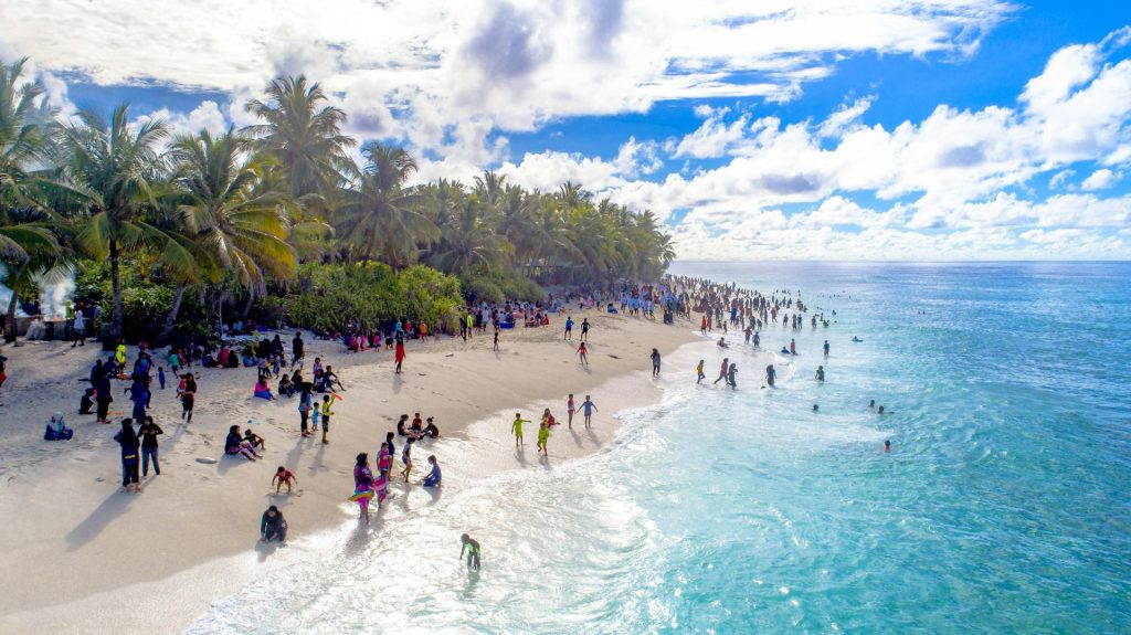 people enjoying a beach in the maldives