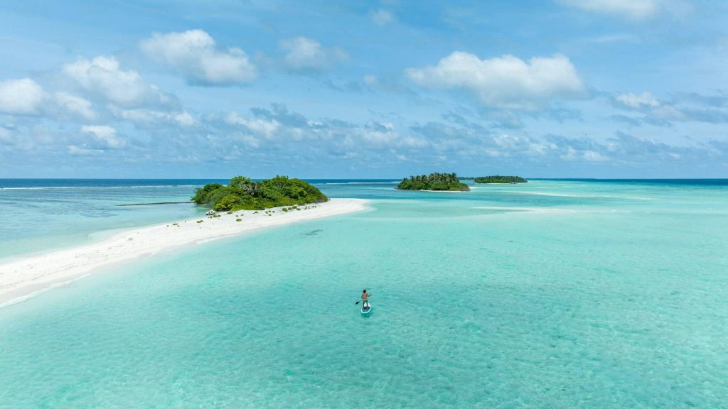 person on a small boat in the maldives