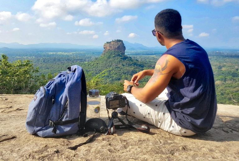 traveller in sri lanka in the top of a mountain