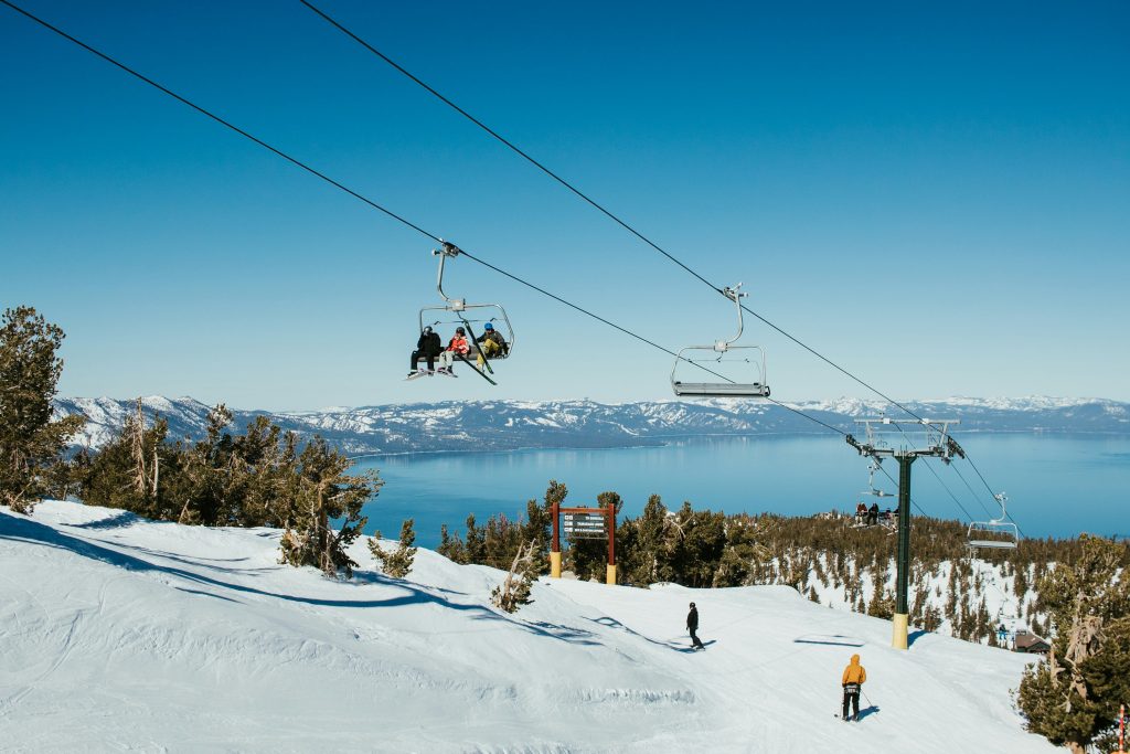 Tourists enjoy the slopes at a ski resort looking over Lake Tahoe.