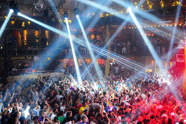 A large group of partygoers dancing in Club Amnesia's Main Room in Ibiza
