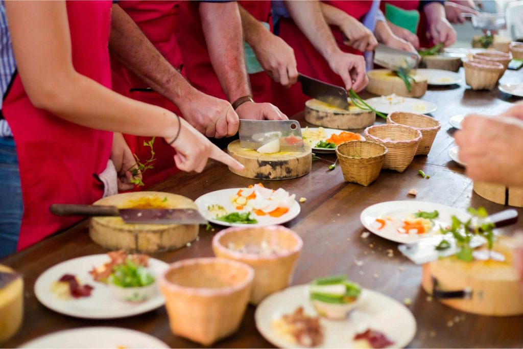 A group of people taking a Thai cooking class