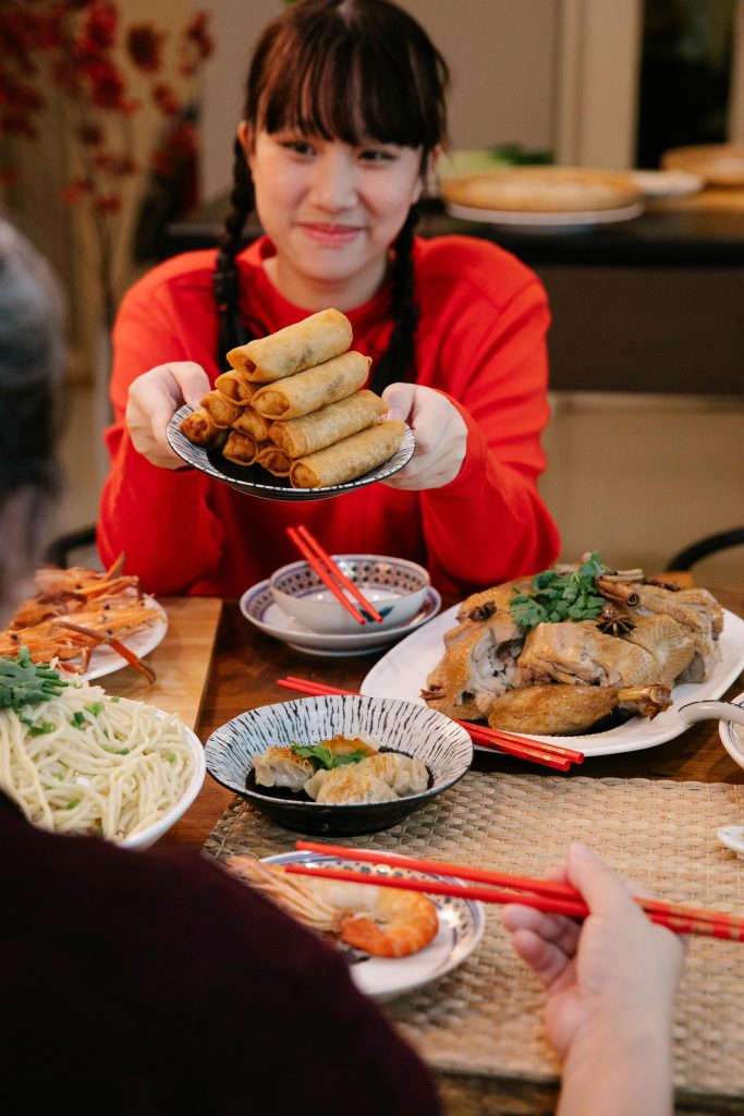 A girl enjoying Chả giò. 