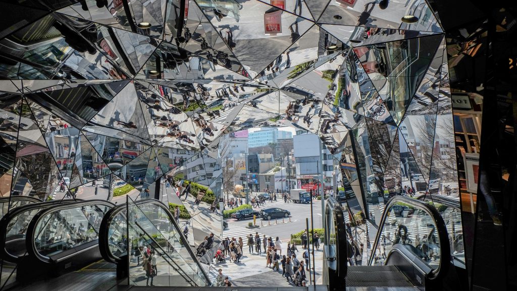 View from inside Omotesando Hills shopping complex looking out to the street, full of mirrors of different angles.