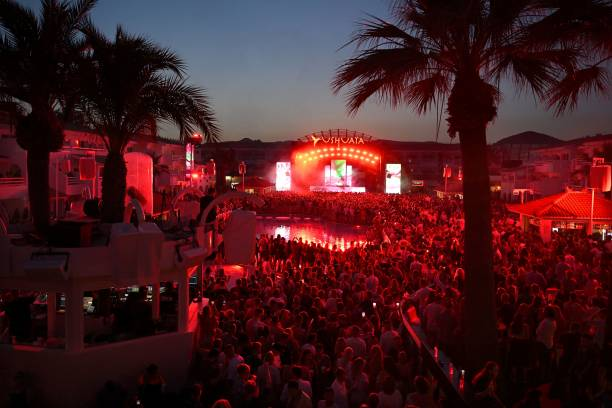 An aerial shot of people partying in Ushuaïa Ibiza Beach Hotel’s open-air clubs at night.