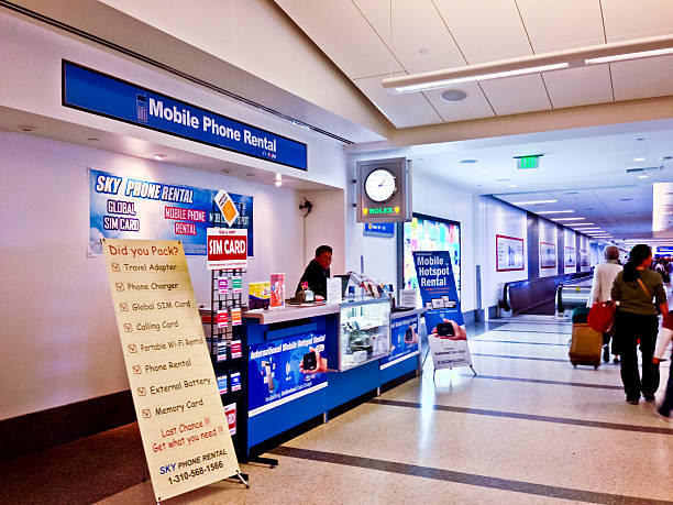 An airport kiosk with blue banners to say they rent out mobile phones and sell SIM cards.