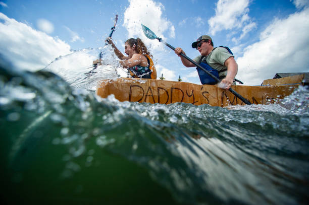 Two locals participating in the Cardboard Boat Regatta during the Salem Maritime Festival. Source: Getty Images