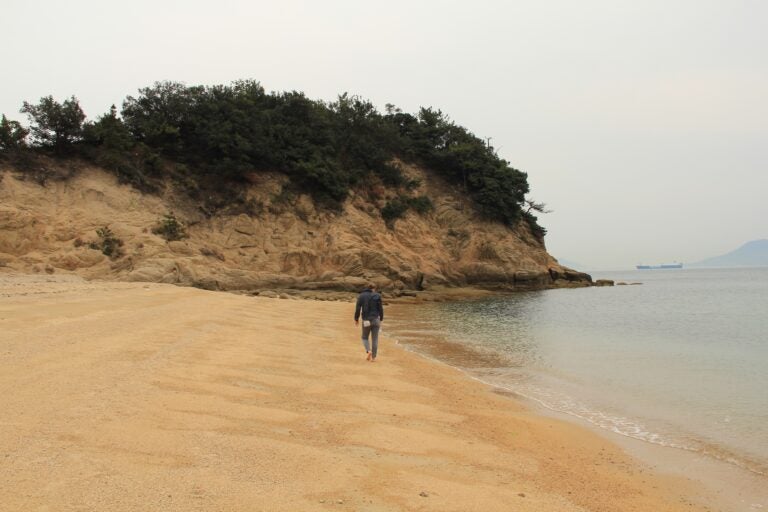 Me exploring the beaches of Noashima, Japan, outside of a seaside museum