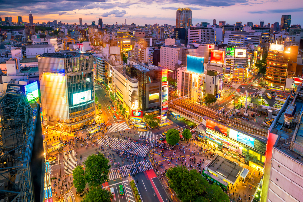 Shibuya Crossing with countless people walking in all directions