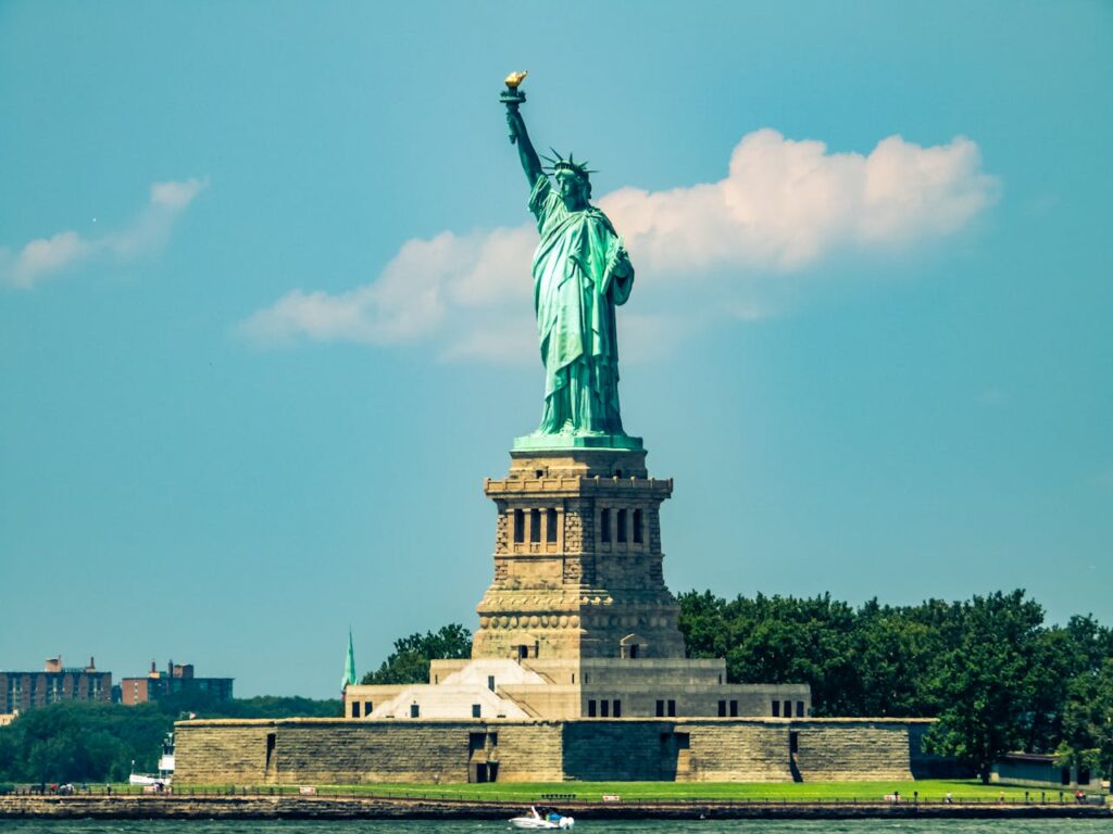 The Statue of Liberty stands majestic against a turquoise sky on Liberty Island. Source: Pexels