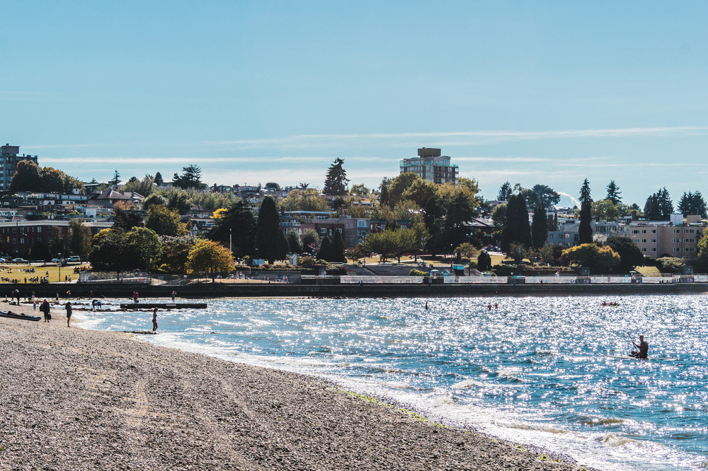 People on the beach and in the water at Kitsilano Beach