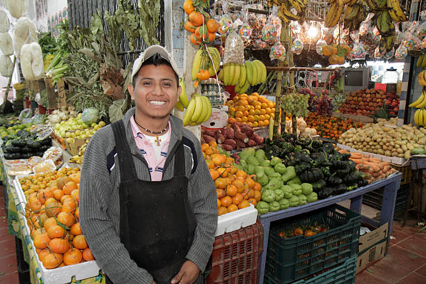 A local in front of the fresh produce at Mercado 23. Source: Getty Images