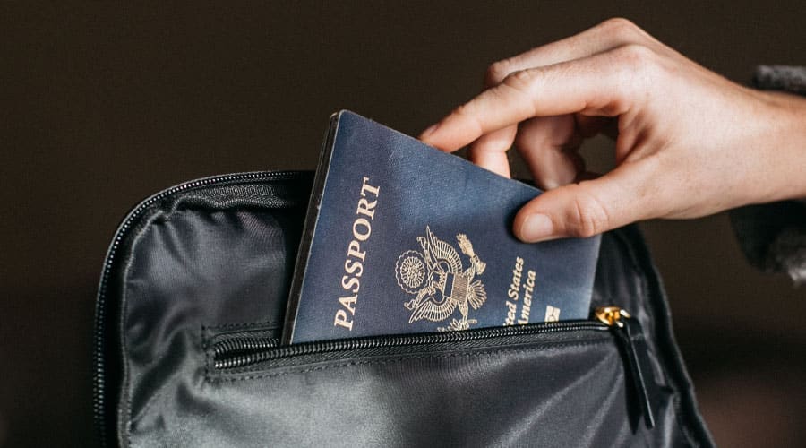 traveler packs their passport
