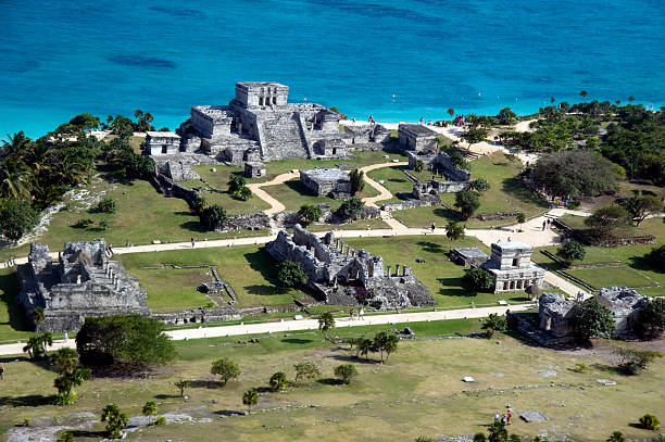 Aerial view of the buildings, pyramids, and pathways of the Tulum Ruins. 