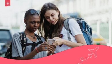 two young women using travel apps for europe