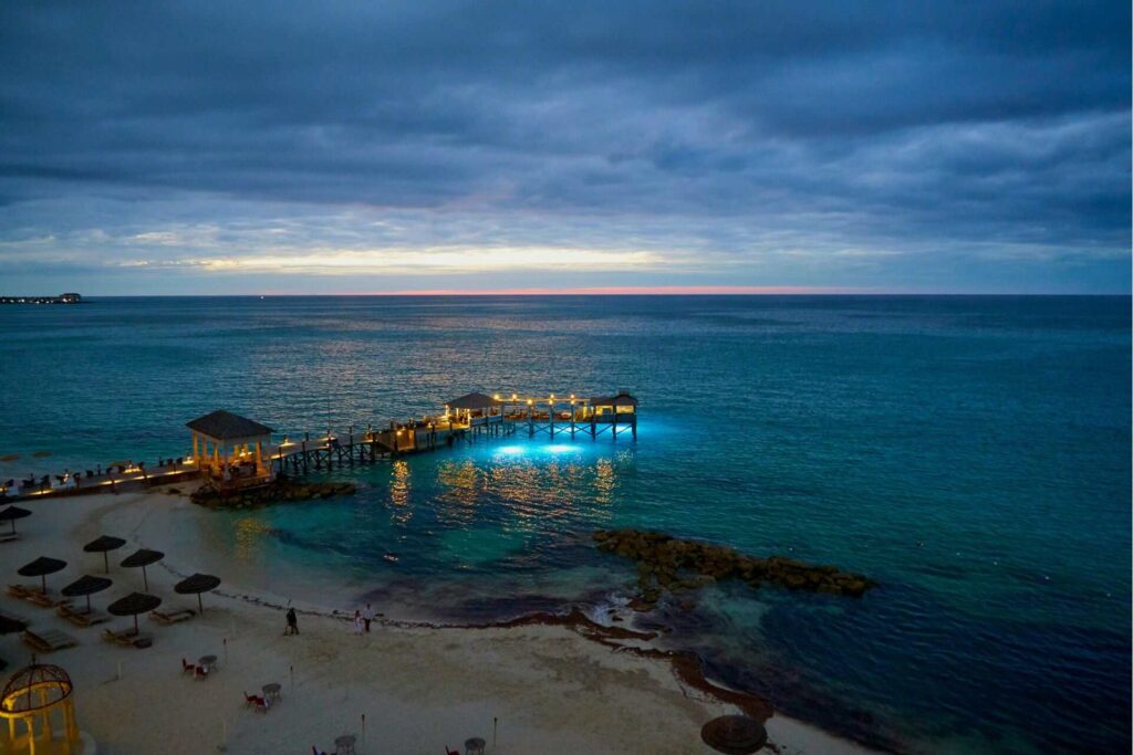 A lit up pier in the Bahamas during sunset