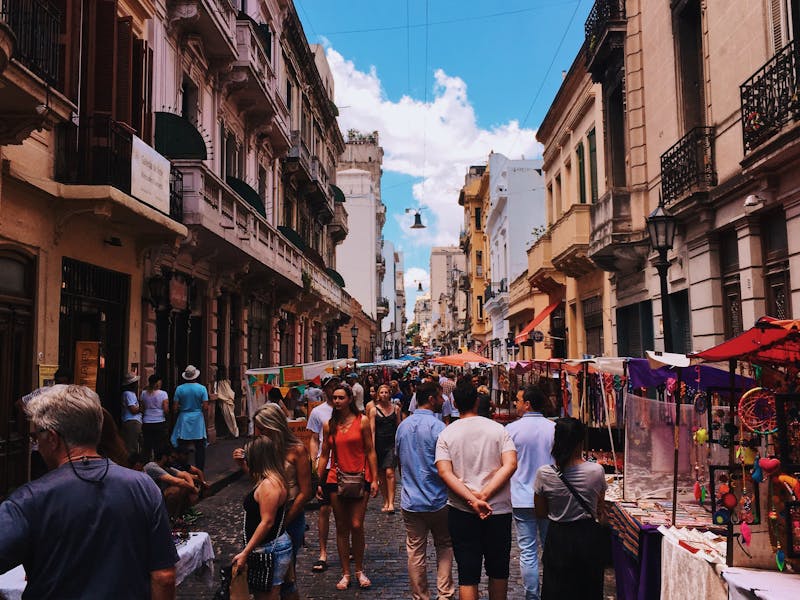 A crowd of people walking through San Nicholas Street in Buenos Aires.
