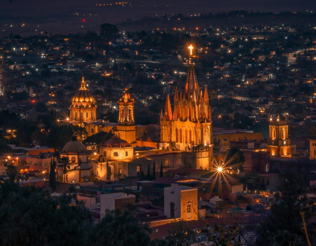 Beautiful cityscape of San Miguel de Allende at dusk with the cathedral at the heart of the scene.