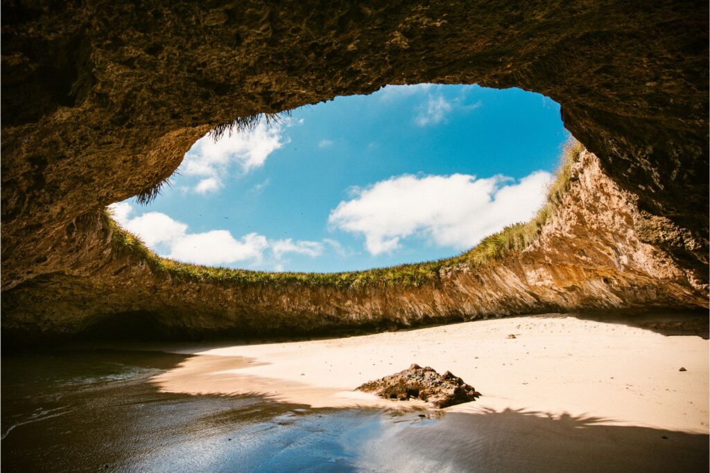 Shot of Playa Escondida, Isla Marieta, Puerto Vallarta, Mexico, amid a blue and cloud-filled sky.