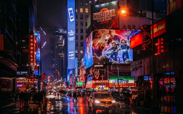 The iconic Times Square in New York City lit up at with billboards and neon advertisements.