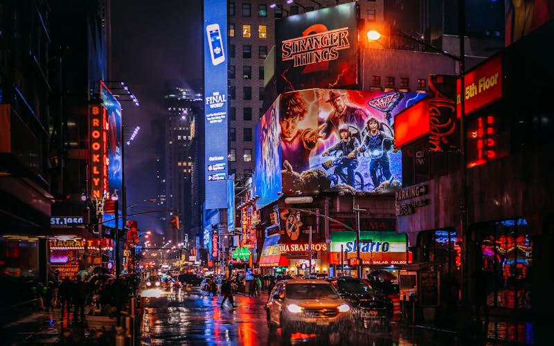 The iconic Times Square in New York City lit up at with billboards and neon advertisements. 