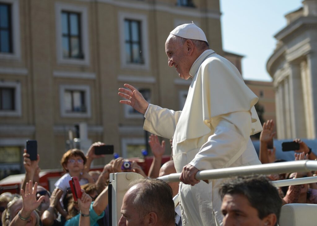 The Pope greets a crowd of pilgrims in St. Peter’s Square, offering a wave of blessing