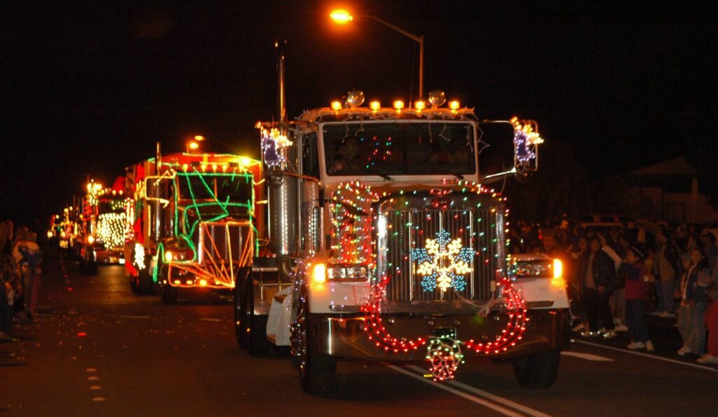 Festive trucks light up the night at Waimea Twilight Parade, spreading holiday cheer.