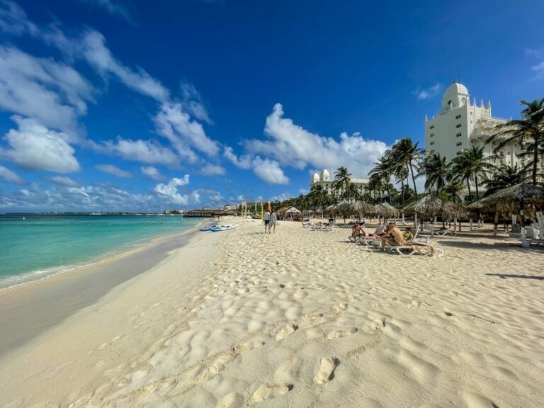 White sandy beaches, blue skies and teal waters on a beach in Aruba