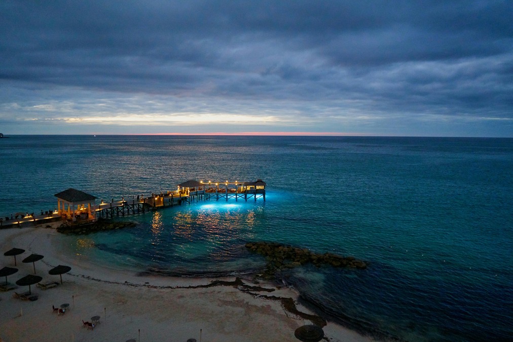 Lights light up a ramp over water in the Bahamas just after sunset 