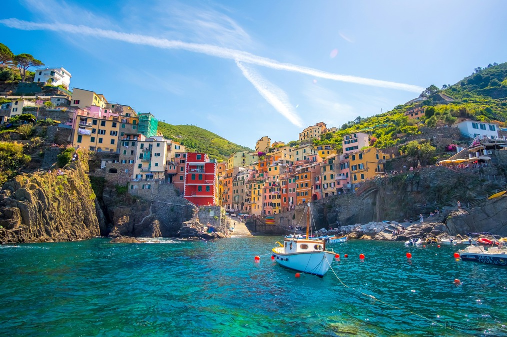 Vibrant blue waters of Cinque Terre against colorful houses