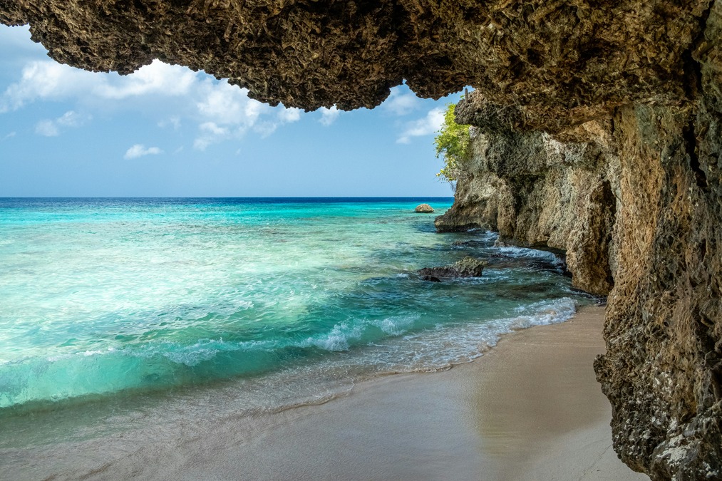 Blue waters crash onto a shore on one of Curacao's secluded beaches 