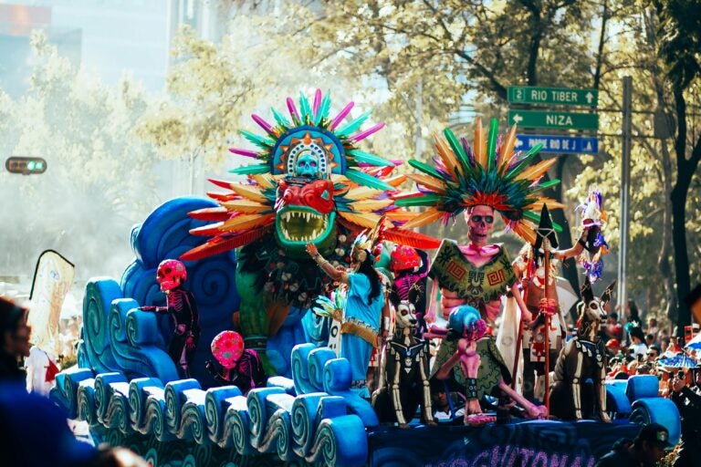 A float during the Día de los Muertos parade in Mexico City, featuring skeletons, gargoyles, and undead dogs.