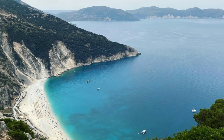 Blue waters crash onto a white, pristine shore in Kefalonia