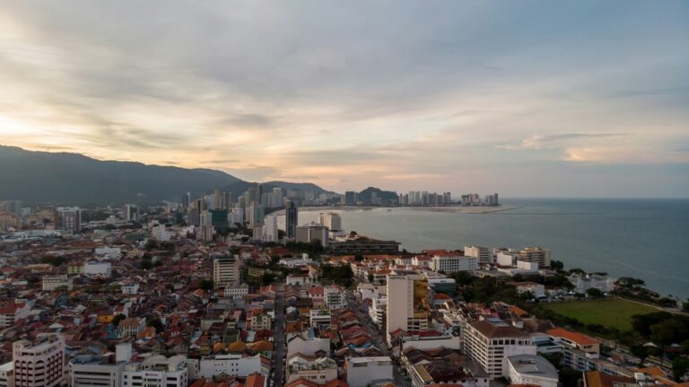 George Town, an accumulation of buildings and houses sit before the shore and sea in Penang, Malaysia