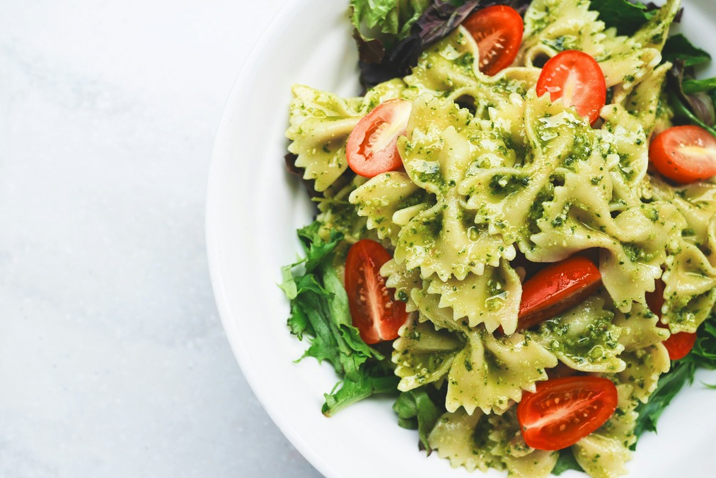 Pesto pasta with tomato, basil, olive oil and a sprinkle of parmesan cheese