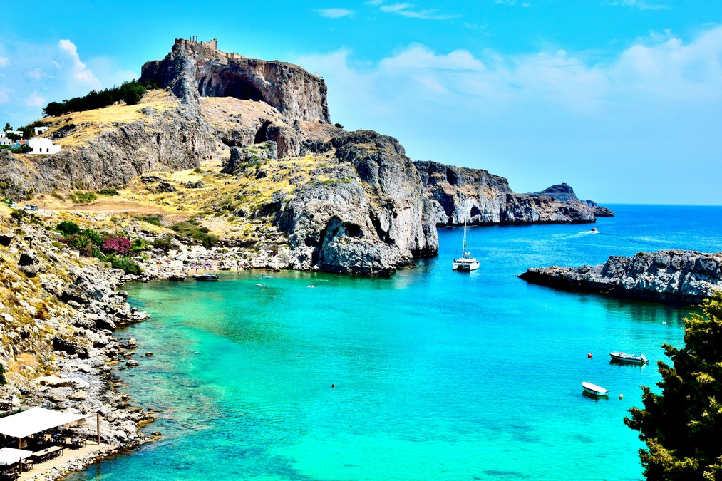 Boats sail through turquoise-teal waters