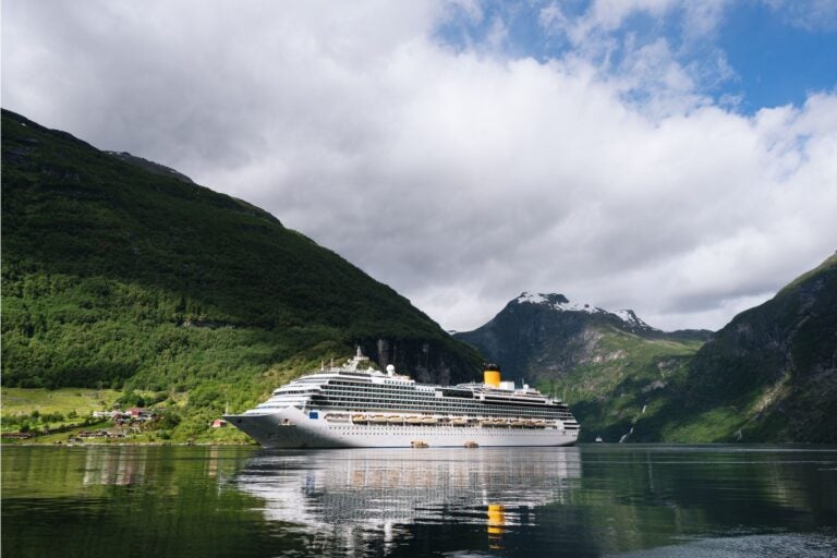 Cruise ship sailing along the fjords of Norway during the summer.