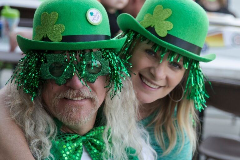 Closeup shot of man and a woman dressed in celebratory St.Patrick's day costumes.