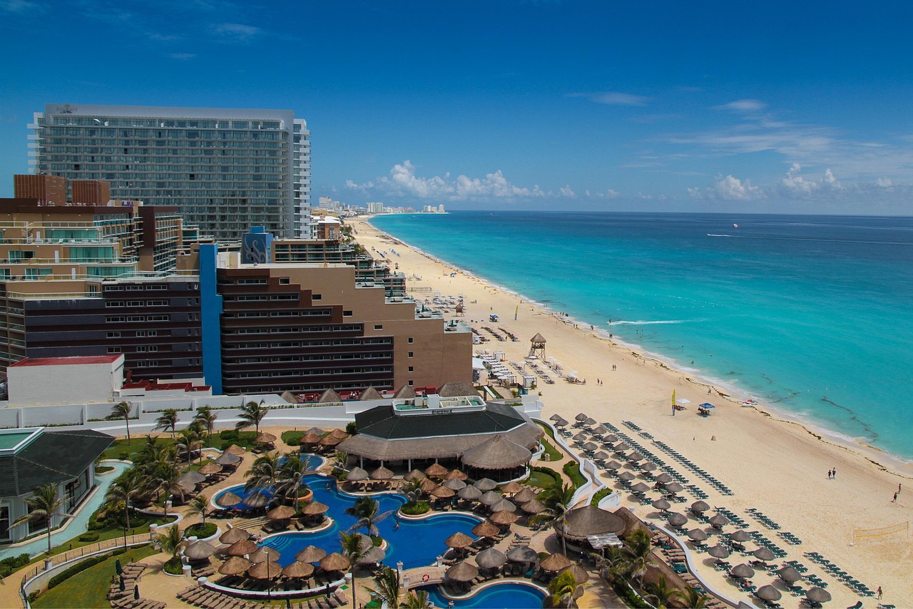 An aerial shot of Playa Chac Mool showing the buildings, beach, and ocean.