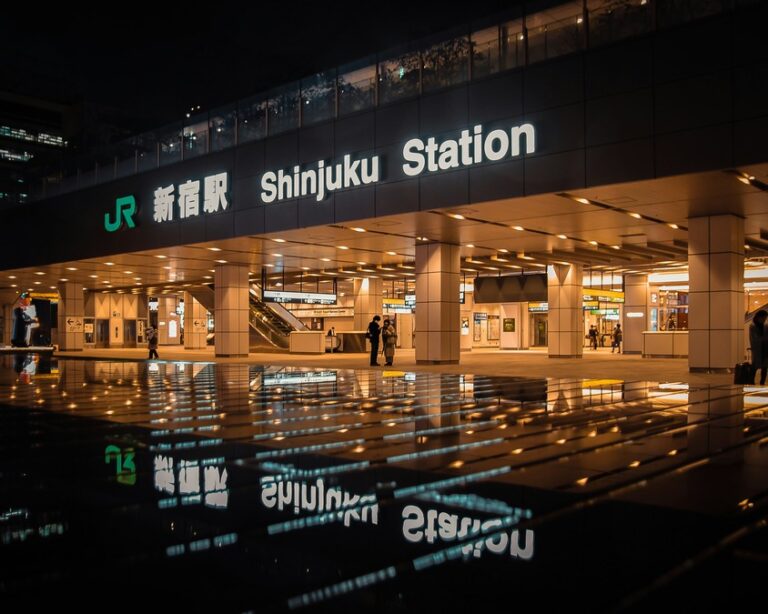 Shinjuku Station lit up with yellow lights 