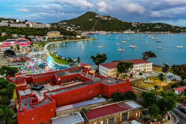 Early evening aerial shot of St. Thomas, with views of the town, shoreline and mountains.
